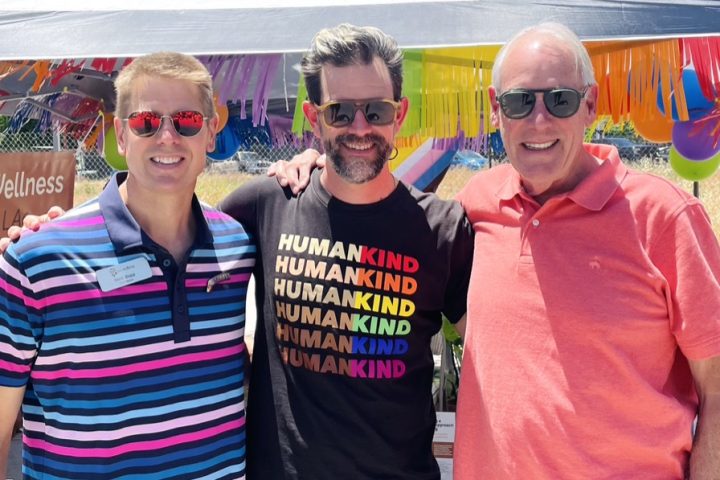 Three men pose at LGBT Pride Festival