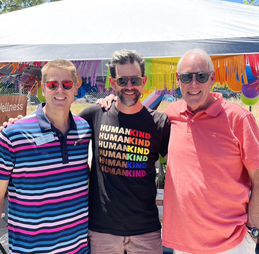 Three men pose at LGBT Pride Festival