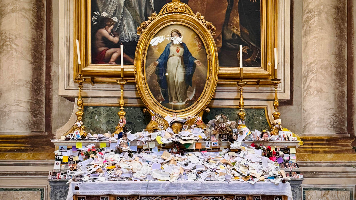 A picture of Mother Mary with a pile of letters at her feet.